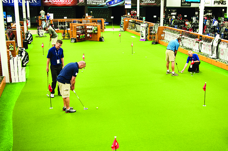 Visitors to the PGA Tour Superstore try out new putters on the STI putting greens, courtesy of Bobby Baughn of STI Atlanta.